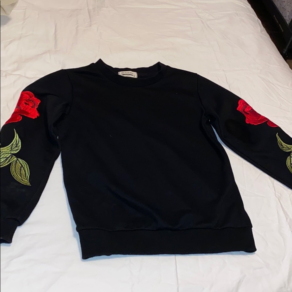 Black sweater with rose detail on sleeve